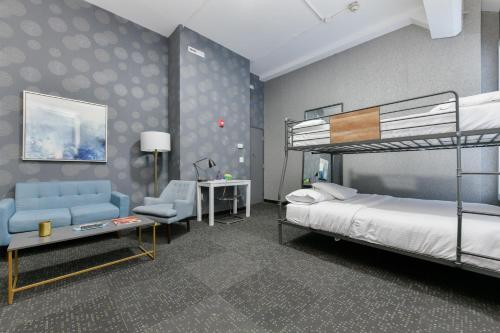 波士顿Temple Place Suites 2+3的一间卧室配有双层床和椅子