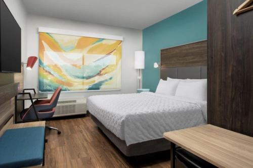 圣安东尼奥Tru By Hilton San Antonio North的配有一张床和一把椅子的酒店客房