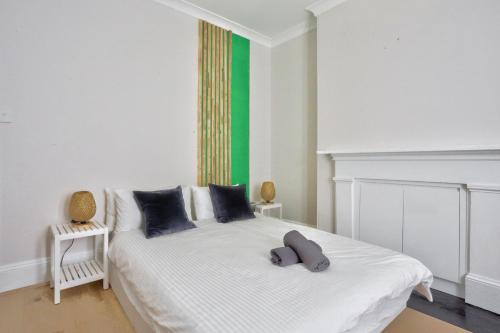 悉尼2 Bedroom House with 2 E-Bikes Included at Centre of Chippendale的一间卧室配有一张白色的床和绿色的墙壁