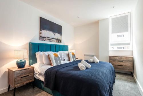 罗瑟勒姆Bright 1 Bedroom Apartment in Central Rotherham的一间卧室配有一张大床和蓝色床头板