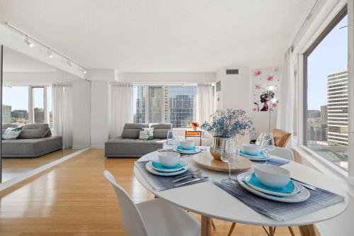 多伦多Modern 2-Bedroom Condo w Floor to Ceiling Windows的白色的用餐室配有白色的桌椅