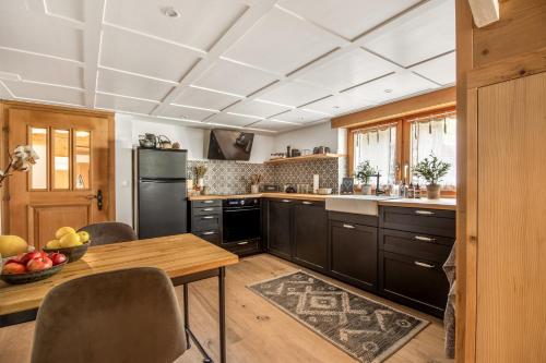 苏姆维特格Casa Pasch - Boutique Bed and Breakfast in Cumpadials的厨房配有木制橱柜和木桌。