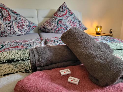 SchmelzMandelas Cozy Lounge的一张带枕头的床和一堆毯子