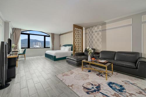 岘港Lupin Center Hotel Danang的客厅配有沙发和1张床