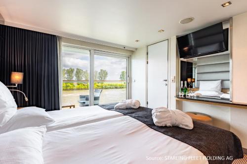 科隆KD Moment Premium Hotelship Köln的一间卧室配有一张大床和两条毛巾