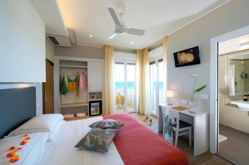 马洛塔UNAWAY Imperial Beach Hotel的一间卧室配有一张大床、一张桌子和一个窗户。