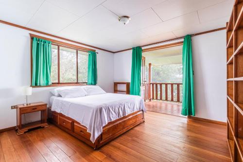 GuariaRefugio San Antonio - 1500 acre Private Preserve的一间卧室配有床和绿色窗帘