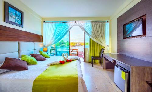阿约拉港索利马尔酒店的一间卧室配有一张带书桌的床和窗户。