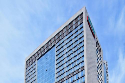 苏州苏州万怡酒店的一座高大的建筑,上面有蓝色的窗户