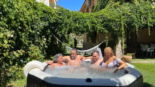 埃尔托尔诺Villa del Jerte的一群人在后院按摩浴缸里
