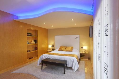 Viñaixa5 bedrooms villa with private pool sauna and terrace at Vinaixa的一间卧室配有一张蓝色天花板的床