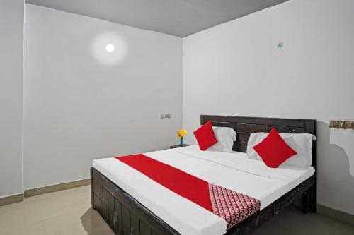 新德里Hotel O Sunrise Villa Near Select Citywalk Mall的一间卧室配有红色和白色枕头的床