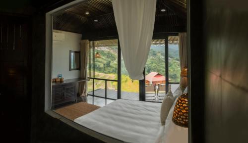 萨帕Black Ship Sapa的一间卧室设有一张床,享有阳台的景色