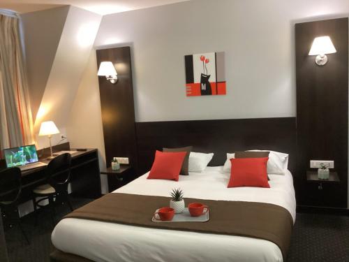 卢尔德联盟酒店的酒店客房配有一张带红色枕头的大床