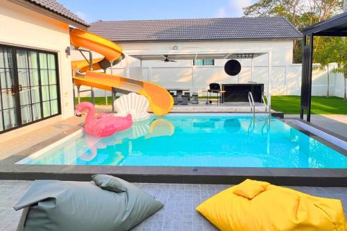 农布BreezyS Pool Villa的一座房子里一个带滑梯的游泳池