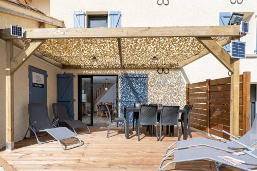 迪涅莱班Plaines-Provence Spa&Sauna的木制庭院配有桌椅