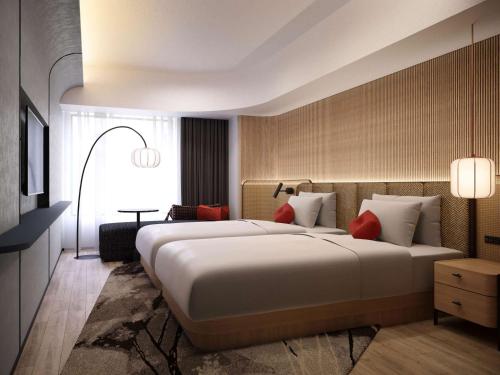 奈良Novotel Nara的酒店客房配有一张带红色枕头的大床