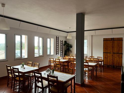 桑塔纳Casa Os Manos的用餐室设有桌椅和窗户。