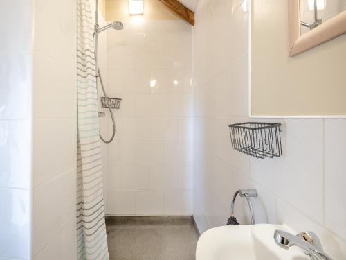 Thorpe Saint PeterIngs Barn的带淋浴和盥洗盆的白色浴室