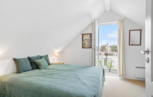 布罗Awesome Home In Brenderup Fyn With 3 Bedrooms, Sauna And Wifi的一间带绿色床的卧室和一个阳台