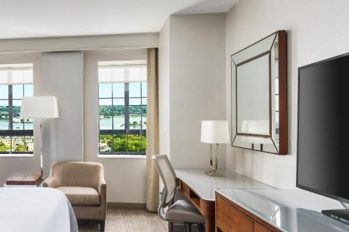 波特兰The Westin Portland Harborview的酒店客房配有一张床、一张书桌和一台电视。