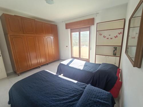 雷焦卡拉布里亚Vista Monte Retreat的一间卧室设有两张床和窗户。