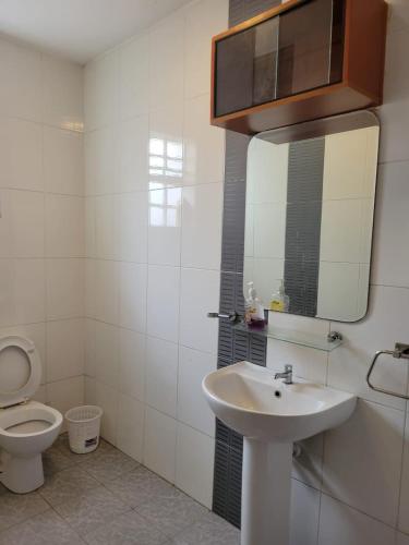基苏木Diana executive residents的一间带卫生间、水槽和镜子的浴室