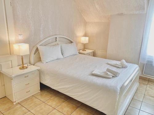 戈内斯Villa Briconico的卧室配有白色的床和2条毛巾