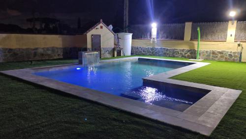 加的斯Villa Zahara de 3 habitaciones con Piscina的夜间在院子里的游泳池