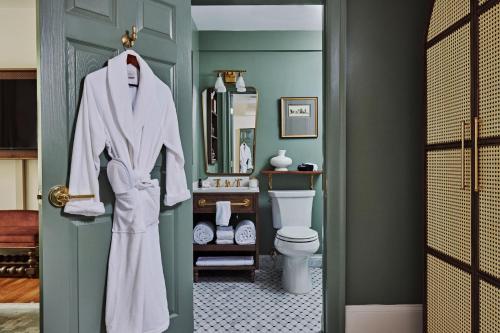 亚特兰大Hotel Granada的浴室的白色长袍挂在门上