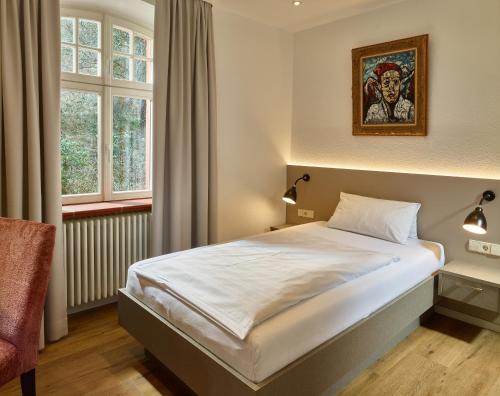 凯撒斯劳滕Hotel & Restaurant Burgschänke的卧室配有一张床,墙上挂着一幅画