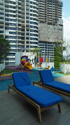 吉隆坡Reizz Residence by Elysium的一个带2把蓝色躺椅的游泳池