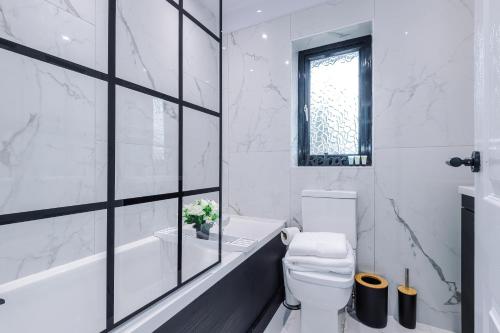 圣海伦斯New 2 Bed House - Perfect for Contractors & Families By AV Stays Short Lets St Helens的白色的浴室设有浴缸和卫生间。