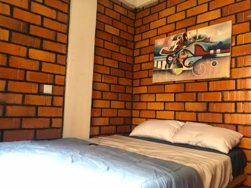 MizingoGinger Homes的一间卧室设有砖墙和床