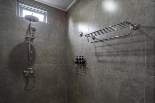 乌布孔雀旅馆的带淋浴的浴室和玻璃门