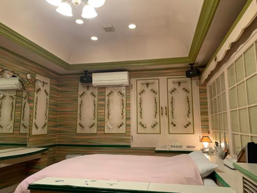Iwakiriホテル　プレリュード的卧室配有一张床、一张书桌和窗户。