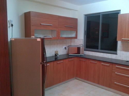 班布里班布里海滩公寓的厨房配有木制橱柜和冰箱。