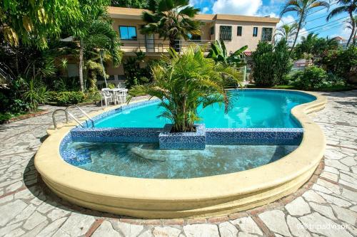 博卡奇卡Hotel Mango的中间有一个棕榈树游泳池