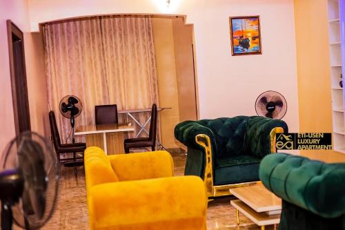 乌约Eti-Usen Apartment的客厅配有绿色沙发和黄色椅子