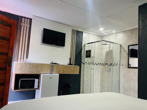 察嫩Executive Galaxy Guest House Nkowankowa Extension 2的带冰箱和淋浴的小厨房
