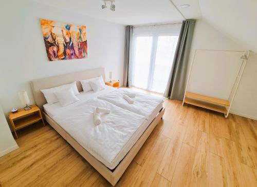 曼兴Apartment Nähe Airbus的一间卧室配有一张带白色床单的大床