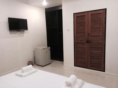 宗通แอทชฎา เชียงใหม่ @Shada Chiang Mai的一间设有床铺和电视的房间,一间设有