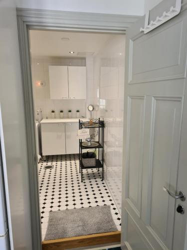 波尔沃Porvoo City Apartments的白色浴室铺有黑白色瓷砖地板。
