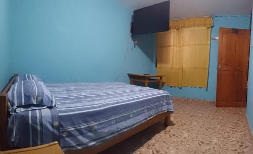特鲁希略Shania的蓝色客房中一间带床的卧室