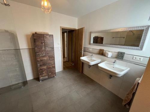 拜尔斯布龙Ferienwohnungen Greve的浴室设有2个水槽和镜子