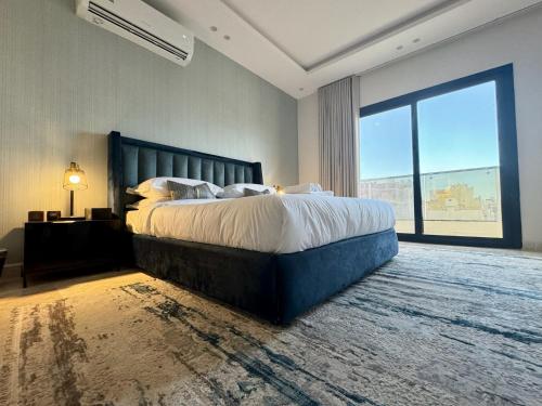 吉达Khozama Living 2 - Alnahda的一间卧室设有一张大床和一个大窗户