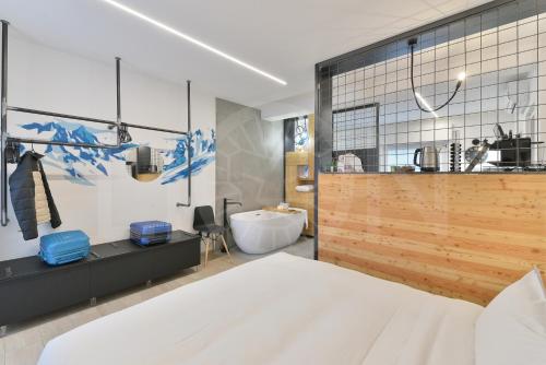 奥斯塔Le Lion Apartments - Bike & Ski的一间带床、浴缸和水槽的浴室