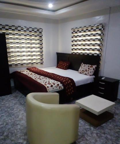 伊凯贾Kemi hotel的一间卧室配有一张床、一张沙发和一把椅子