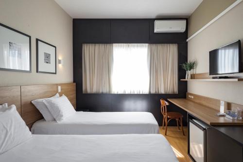 弗洛里亚诺波利斯坎比莱拉酒店的酒店客房配有两张床和一张书桌