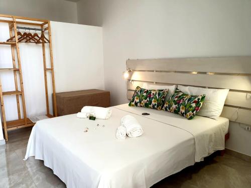 卡斯特里尼亚诺德尔卡波Le Stanze del Salento的卧室配有一张带2条毛巾的大型白色床